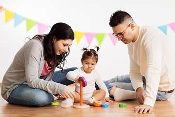 Image showing baby girl with parents playing with pyramid toy