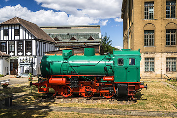 Image showing Green and red locomotive on tracks