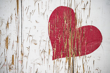 Image showing Red heart scratched in wood in red color