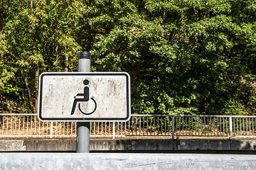 Image showing Dirty handicap sign with a wheel chair