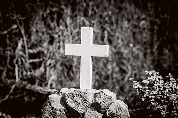 Image showing White cross on a tomb in sepia colors