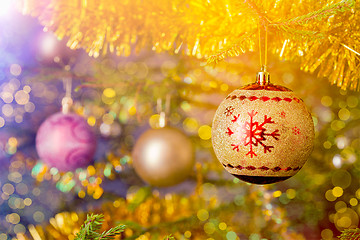 Image showing Christmas-tree decoration bauble on decorated Christmas tree bac