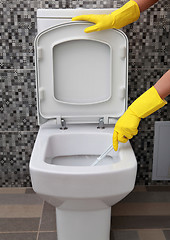 Image showing yellow rubber gloves and toilet bowl 