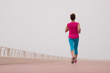 Image showing woman busy running on the promenade