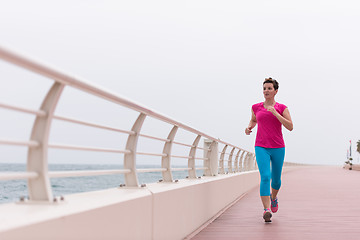 Image showing woman busy running on the promenade
