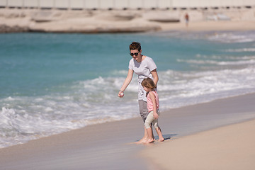 Image showing mother and daughter running on the beach