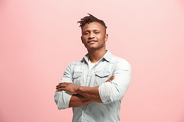 Image showing The happy business man standing and smiling against pink background.