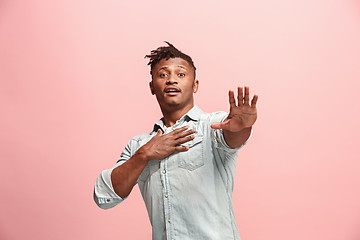 Image showing Handsome man looking suprised isolated on pink