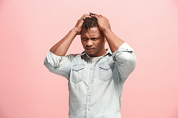 Image showing African American Man having headache. Isolated over pink background.