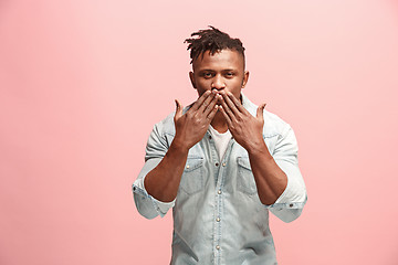 Image showing Portrait of attractive Afro-American man with air kiss isolated over pink background