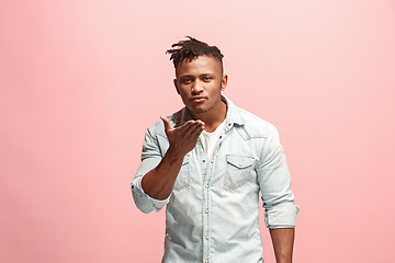 Image showing Portrait of attractive Afro-American man with air kiss isolated over pink background