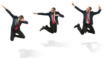 Image showing Funny cheerful businessman jumping in air over white background