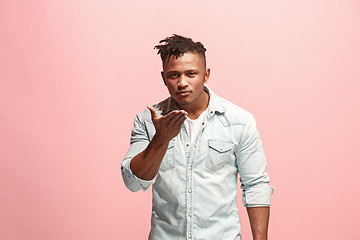 Image showing Portrait of attractive Afro-American man with air kiss isolated over pink background