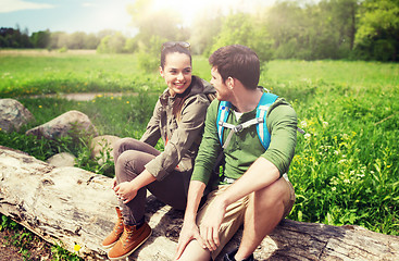 Image showing smiling couple with backpacks in nature