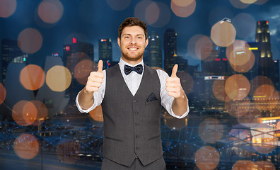 Image showing happy man  showing thumbs up over singapore city