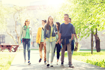 Image showing group of happy teenage students walking outdoors