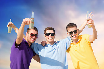 Image showing male friends with bottles of drink