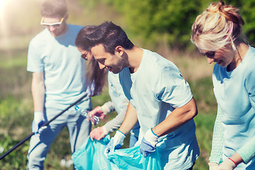 Image showing volunteers with garbage bags cleaning park area