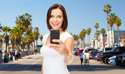 Image showing woman taking selfie by smartphone in los angeles