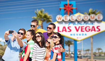 Image showing group of happy friends taking selfie by cell phone