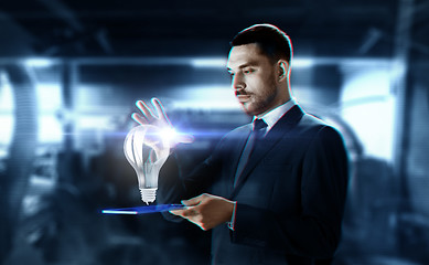 Image showing businessman with transparent tablet and hologram