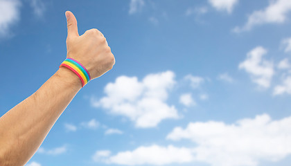 Image showing hand with gay pride rainbow wristband shows thumb