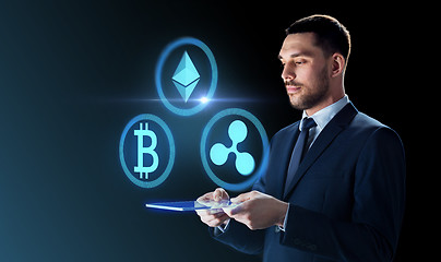 Image showing businessman with tablet pc and cryptocurrency