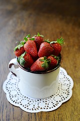 Image showing strawberry in a mug on a wooden table