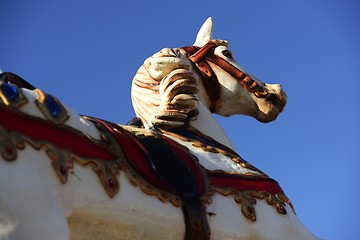 Image showing carousel horse in an amusement park on a blue sky