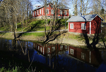 Image showing typical finnish wooden houses on the river bank