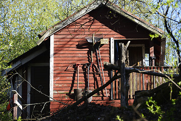 Image showing red garden wooden  shed and tools