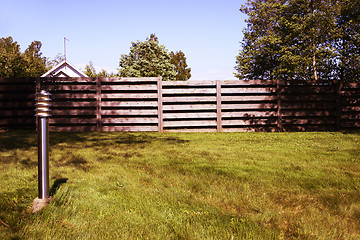 Image showing lantern, green lawn and fence, photo filter