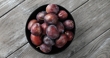 Image showing Bowl of wet ripe plums