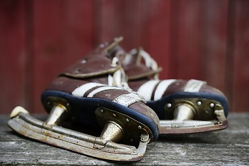 Image showing vintage pair of mens  ice skates on the bench