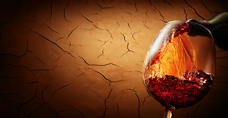 Image showing Wine on cracked clay background