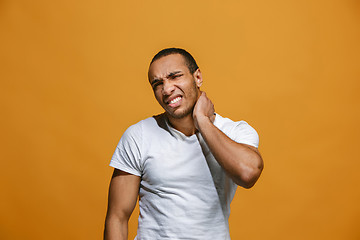 Image showing Young man overwhelmed with a pain in the neck