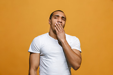 Image showing Beautiful bored man bored isolated on orange background