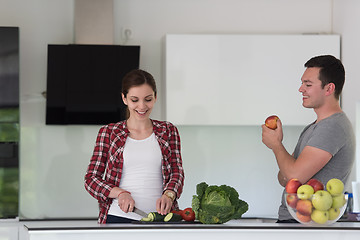 Image showing Young handsome couple in the kitchen