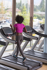 Image showing afro american woman running on a treadmill