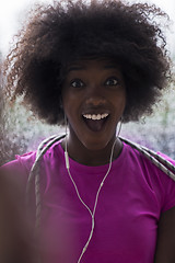 Image showing portrait of young afro american woman in gym while listening mus