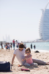 Image showing Mom and daughter on the beach