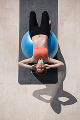 Image showing woman doing exercise with pilates ball top view