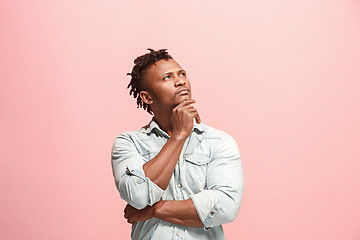 Image showing Young serious thoughtful Afro-American businessman. Doubt concept.