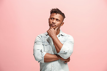 Image showing Young serious thoughtful Afro-American businessman. Doubt concept.