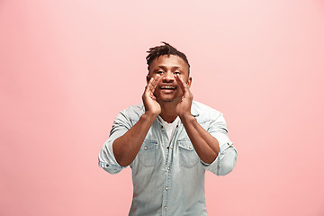 Image showing Isolated on pink young Afro-American man shouting at studio