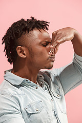 Image showing Let me think. Doubtful pensive Afro-American man with thoughtful expression making choice against pink background