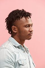 Image showing Beautiful Afro-American man looking suprised and bewildered isolated on pink