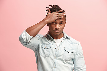 Image showing African American Man having headache. Isolated over pink background.