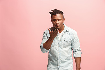 Image showing Portrait of attractive Afro-American man with air kiss isolated over pink background