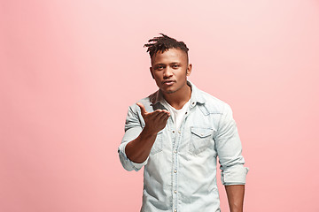 Image showing Portrait of attractive Afro-American man with air kiss isolated over pink background